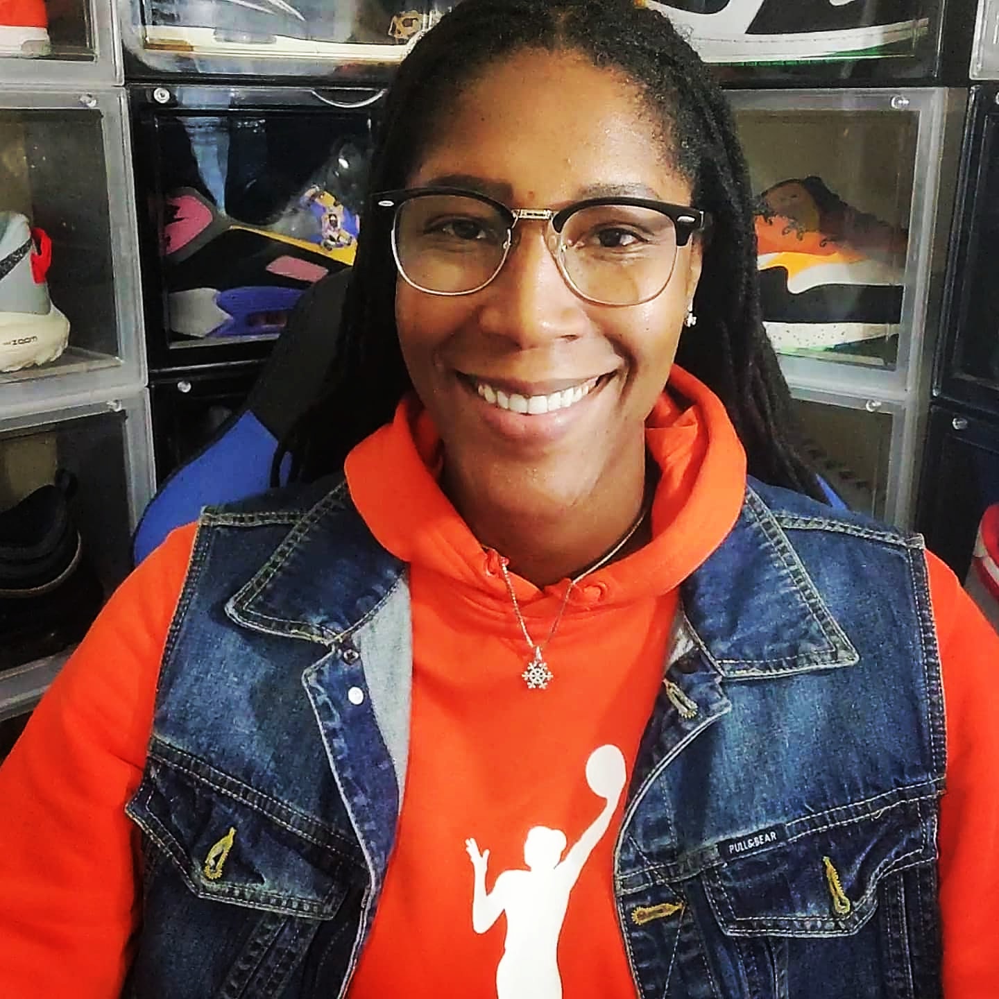 Michelle Snow, keynote speaker and creator of PRO MOVE, wearing an orange basketball hoodie and denim vest